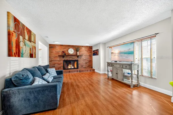 a living room with furniture and a floor to ceiling window