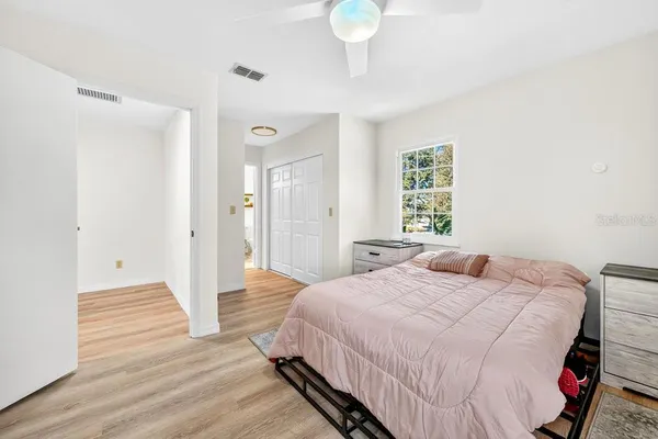 a bedroom with a bed and a chandelier