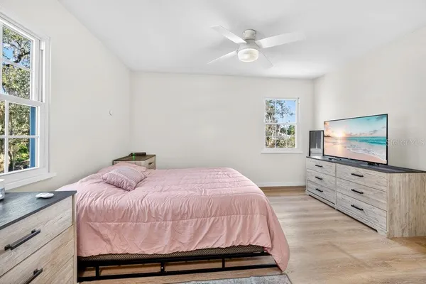 a bedroom with a bed and a flat screen tv