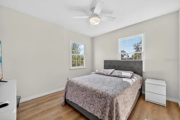 a bedroom with a bed and a window