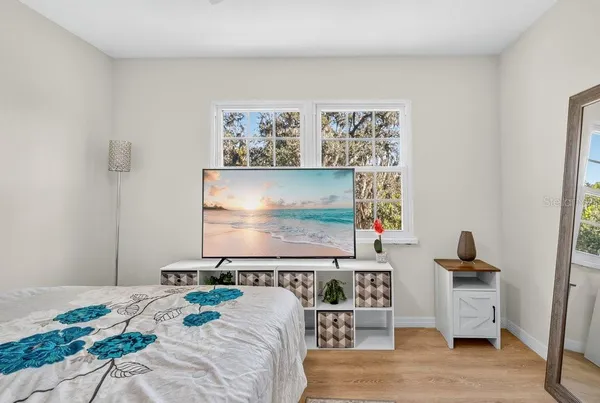 a bedroom with a bed and a flat screen tv