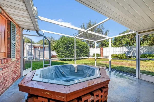 a view of a backyard with swimming pool and porch