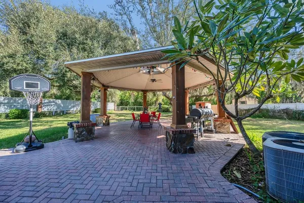 a view of a patio with table and chairs under an umbrella
