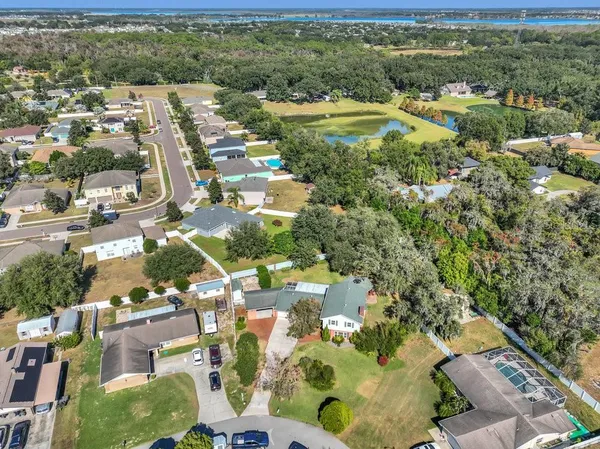 an aerial view of residential houses with outdoor space and river