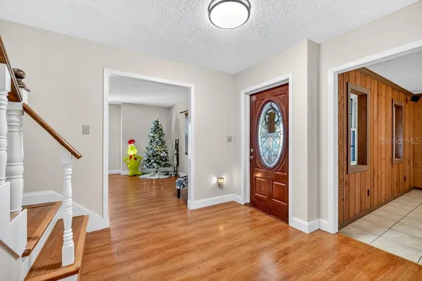 a view of an entryway with wooden floor