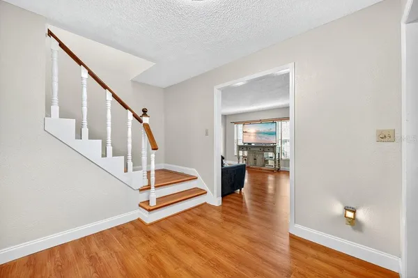 a view of entryway and hall with wooden floor