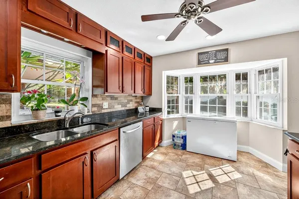 a kitchen with stainless steel appliances granite countertop a sink and a stove