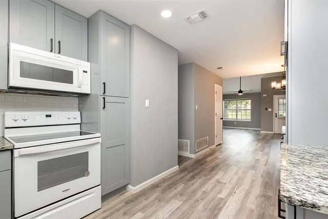 a view of a kitchen with a stove cabinets and a wooden floor