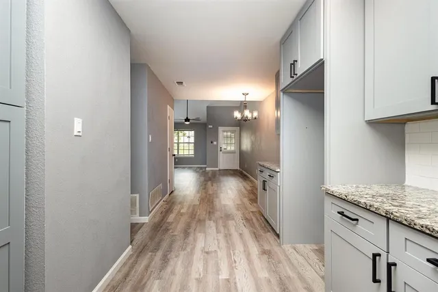 a view of hallway with wooden floor