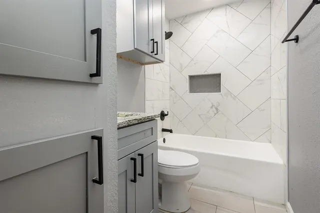 a bathroom with a sink a toilet and bathtub