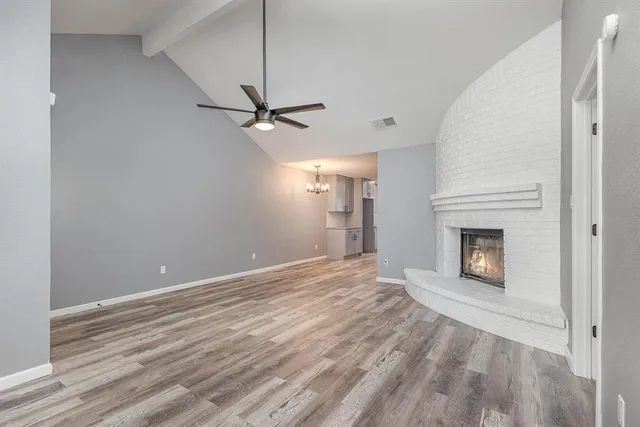 a view of an empty room with a fireplace