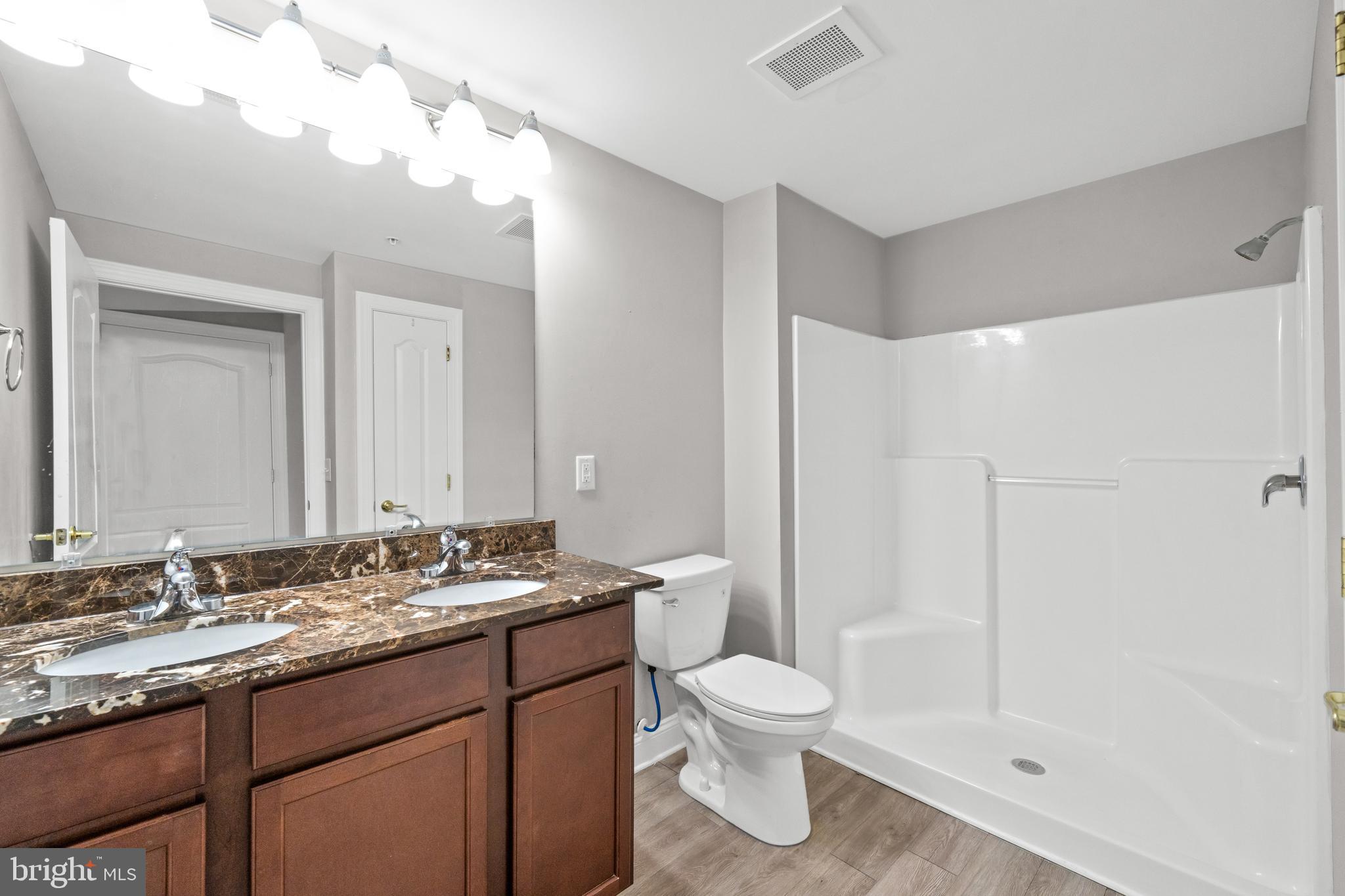3000 Fountainview Circle, Unit 301 Newark, DE 19713 - Photo 16 of 17 a bathroom with a granite countertop sink toilet and shower