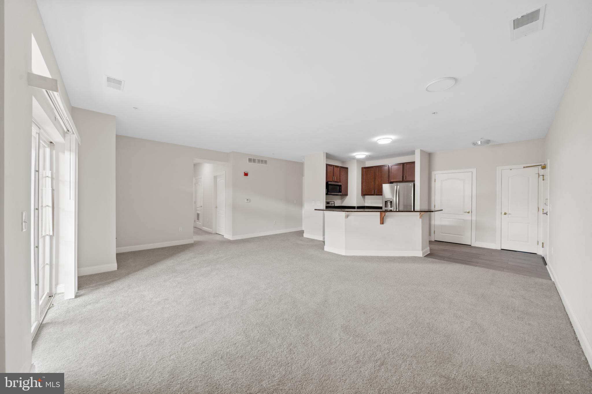 3000 Fountainview Circle, Unit 301 Newark, DE 19713 - Photo 6 of 17 a view of a kitchen with a sink and a refrigerator