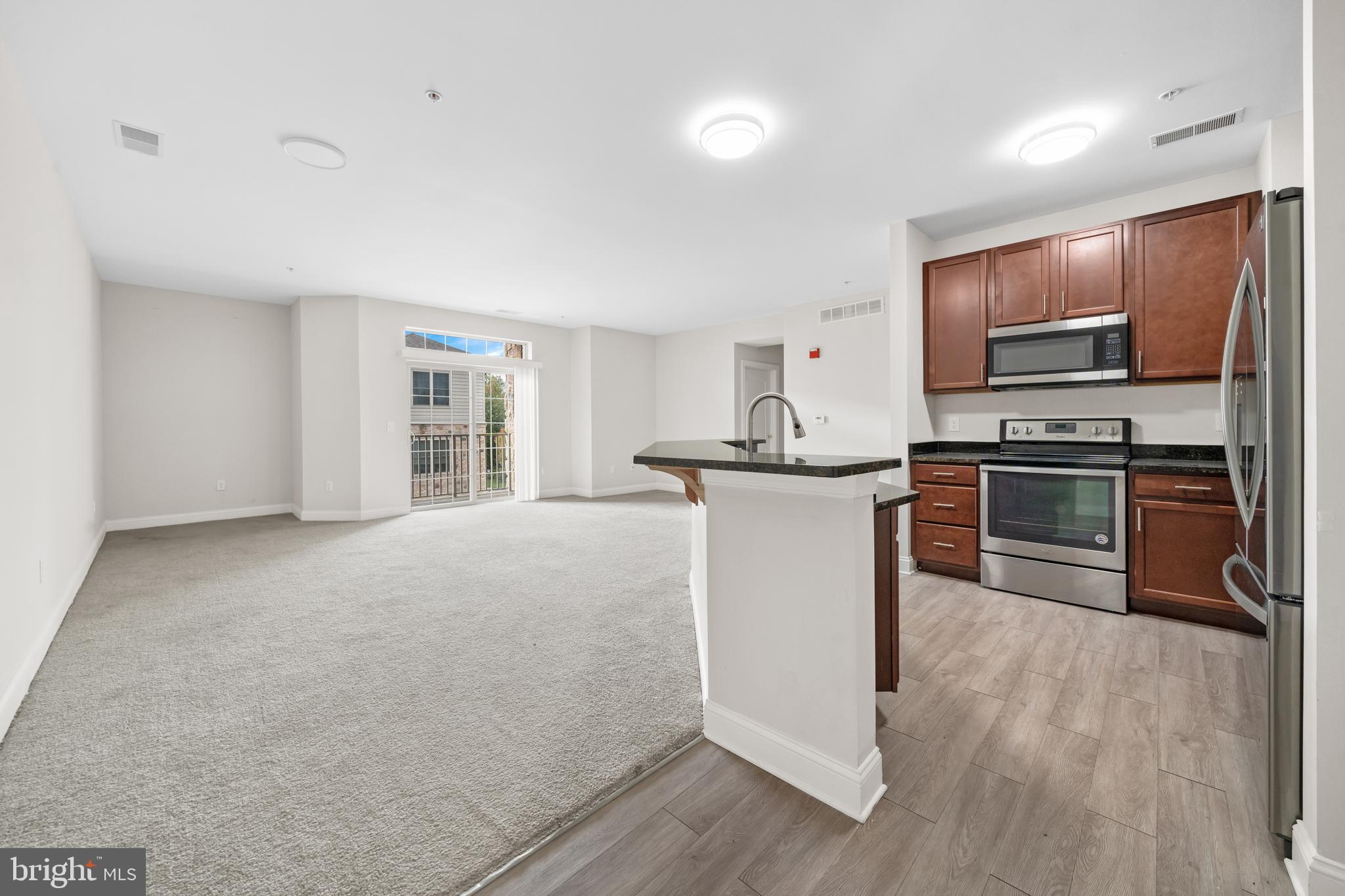 3000 Fountainview Circle, Unit 301 Newark, DE 19713 - Photo 7 of 17 a kitchen with cabinets and stainless steel appliances