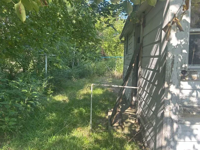a backyard of a house with a yard and outdoor seating