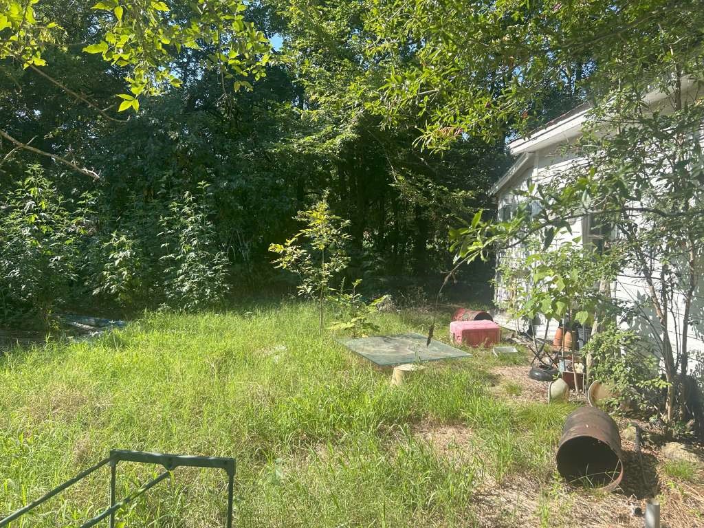 500 East McKinney Avenue Cooper, TX 75432 - Photo 4 of 5 a backyard of a house with a yard and outdoor seating