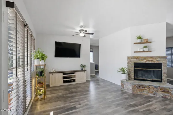 a living room with furniture a fireplace and a flat screen tv