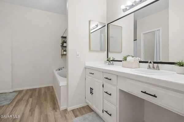 a bathroom with a double vanity sink and mirror