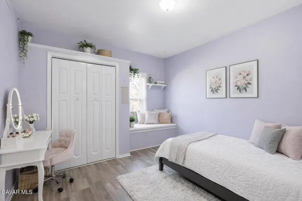 a bedroom with a bed and a table