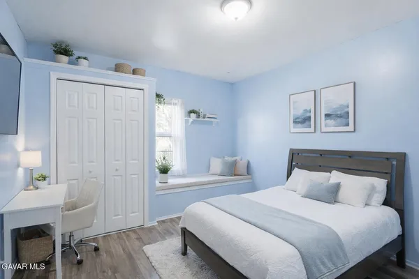 a bedroom with a bed and a table