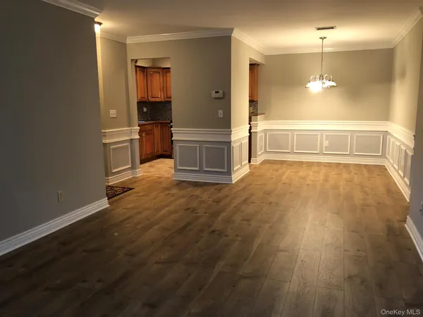 a view of a kitchen with wooden floor and a sink