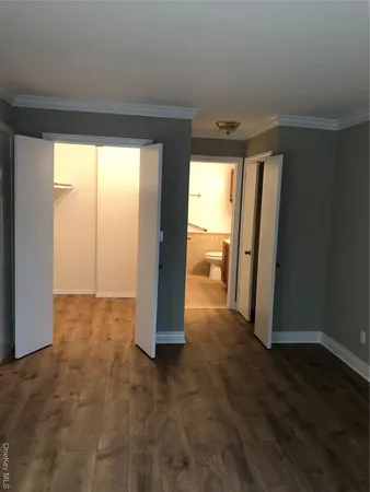 a view of an empty room and wooden floor