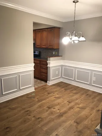 a kitchen with a cabinets and chandelier