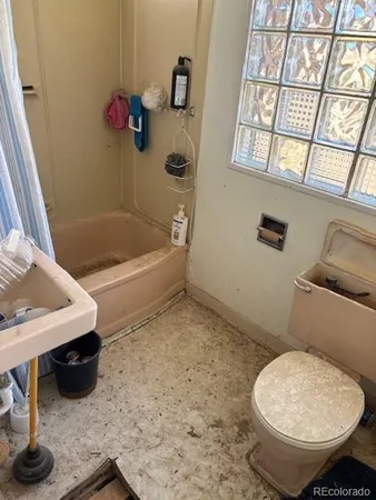 a bathroom with a toilet and a bathtub