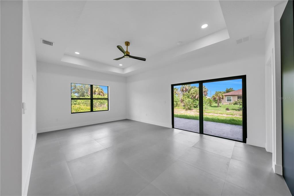 2328 Irondale Road North Port, FL 34287 - Photo 13 of 45 an empty room with windows and ceiling fan