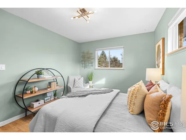 a bedroom with bed and a mirror