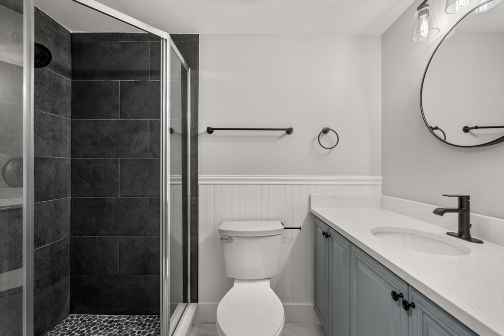 5 Main Street, Unit 5 Boston, MA 02129 - Photo 15 of 19 a bathroom with a toilet a sink and a mirror