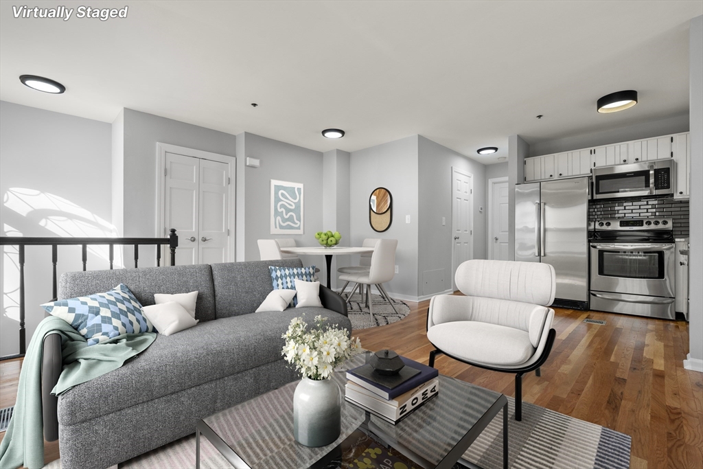 5 Main Street, Unit 5 Boston, MA 02129 - Photo 2 of 19 a living room with furniture kitchen view and a wooden floor
