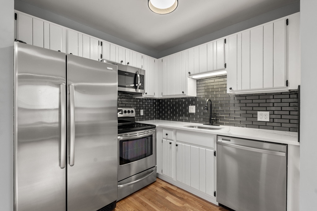 5 Main Street, Unit 5 Boston, MA 02129 - Photo 7 of 19 a kitchen with stainless steel appliances cabinets a sink and a window