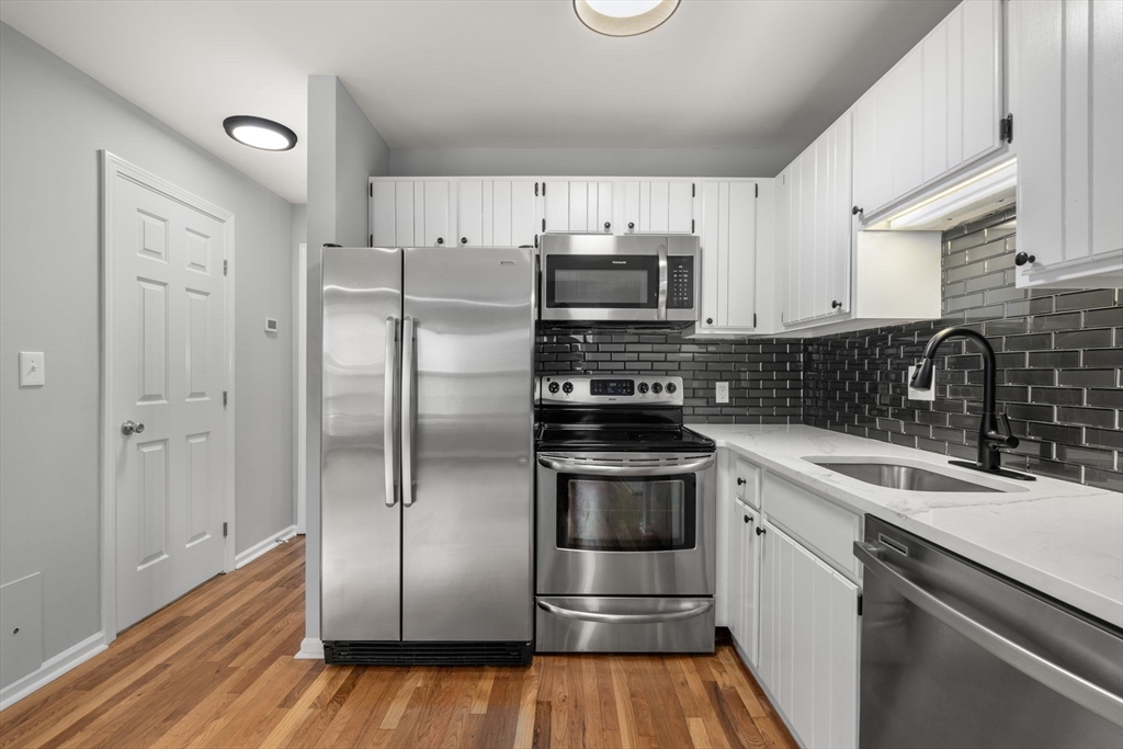 5 Main Street, Unit 5 Boston, MA 02129 - Photo 8 of 19 a kitchen with granite countertop a refrigerator and a sink