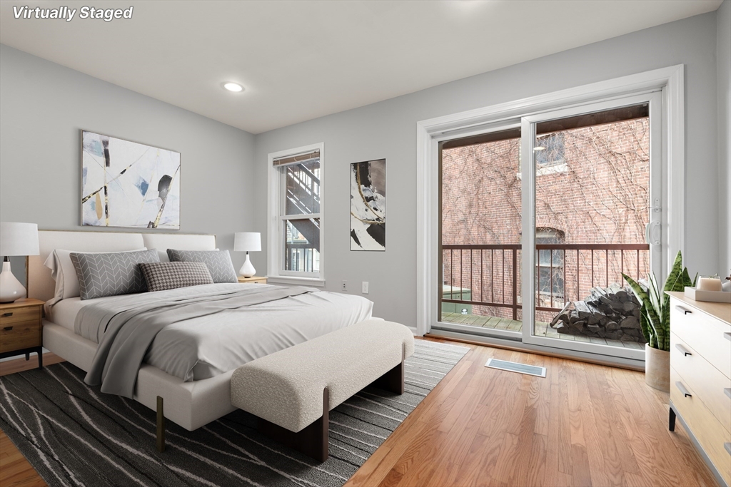 5 Main Street, Unit 5 Boston, MA 02129 - Photo 9 of 19 a spacious bedroom with a bed and a large window