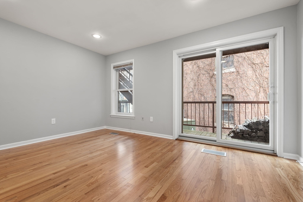 5 Main Street, Unit 5 Boston, MA 02129 - Photo 10 of 19 a view of an empty room with wooden floor and a window