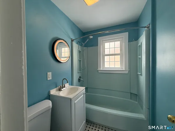 a bathroom with a toilet sink and mirror