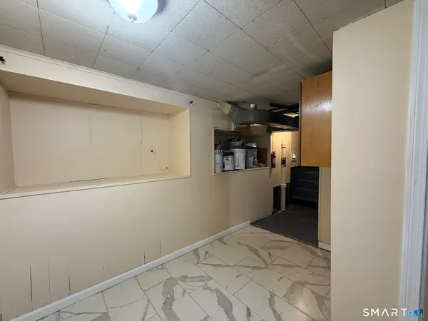a view of a hallway with wooden shelves