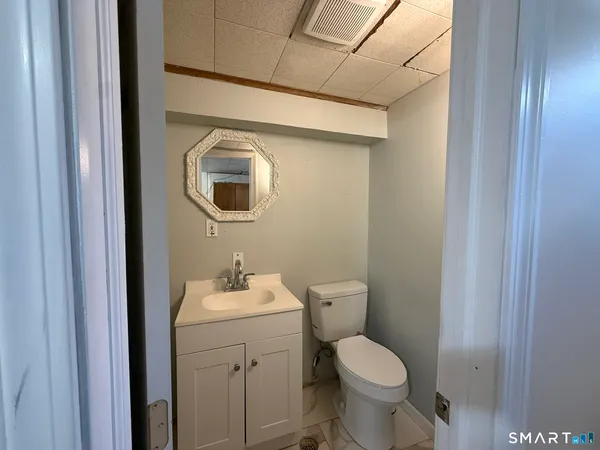 a bathroom with a toilet sink and mirror