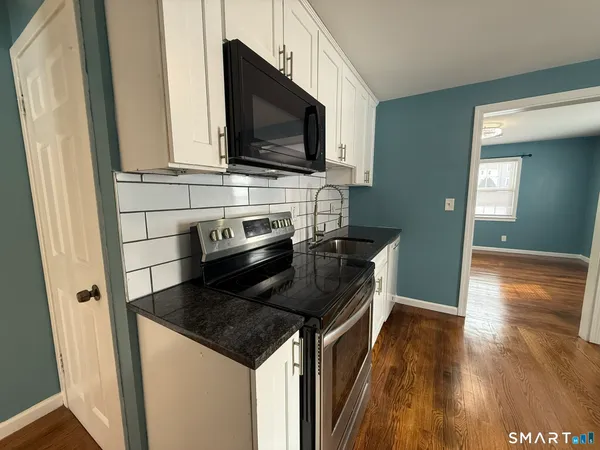 a kitchen with stainless steel appliances a microwave a stove and a microwave