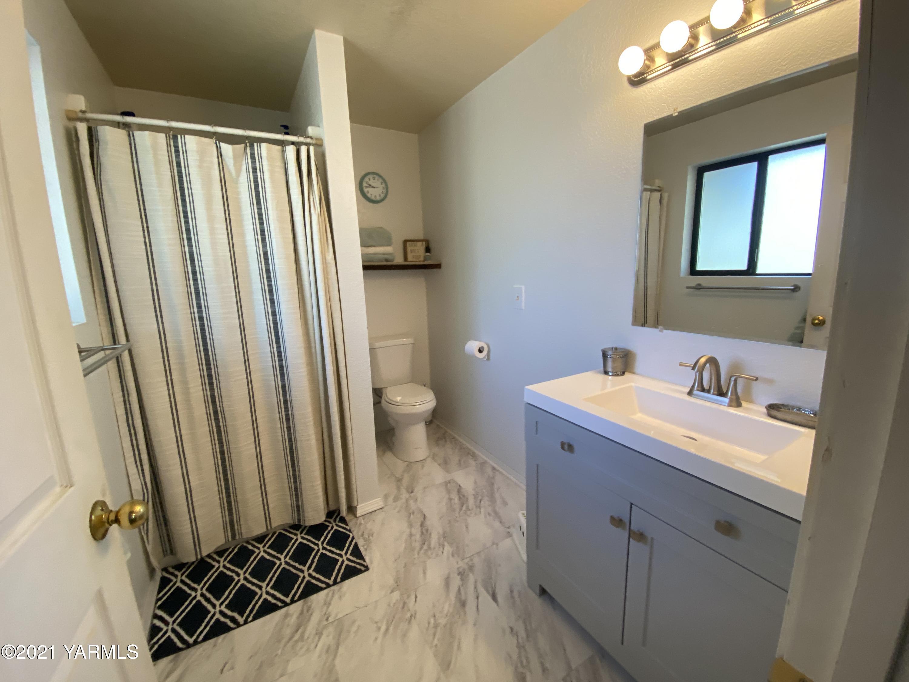 1260 Beffa Road Tieton, WA 98947 - Photo 18 of 38 a bathroom with a granite countertop sink toilet and shower