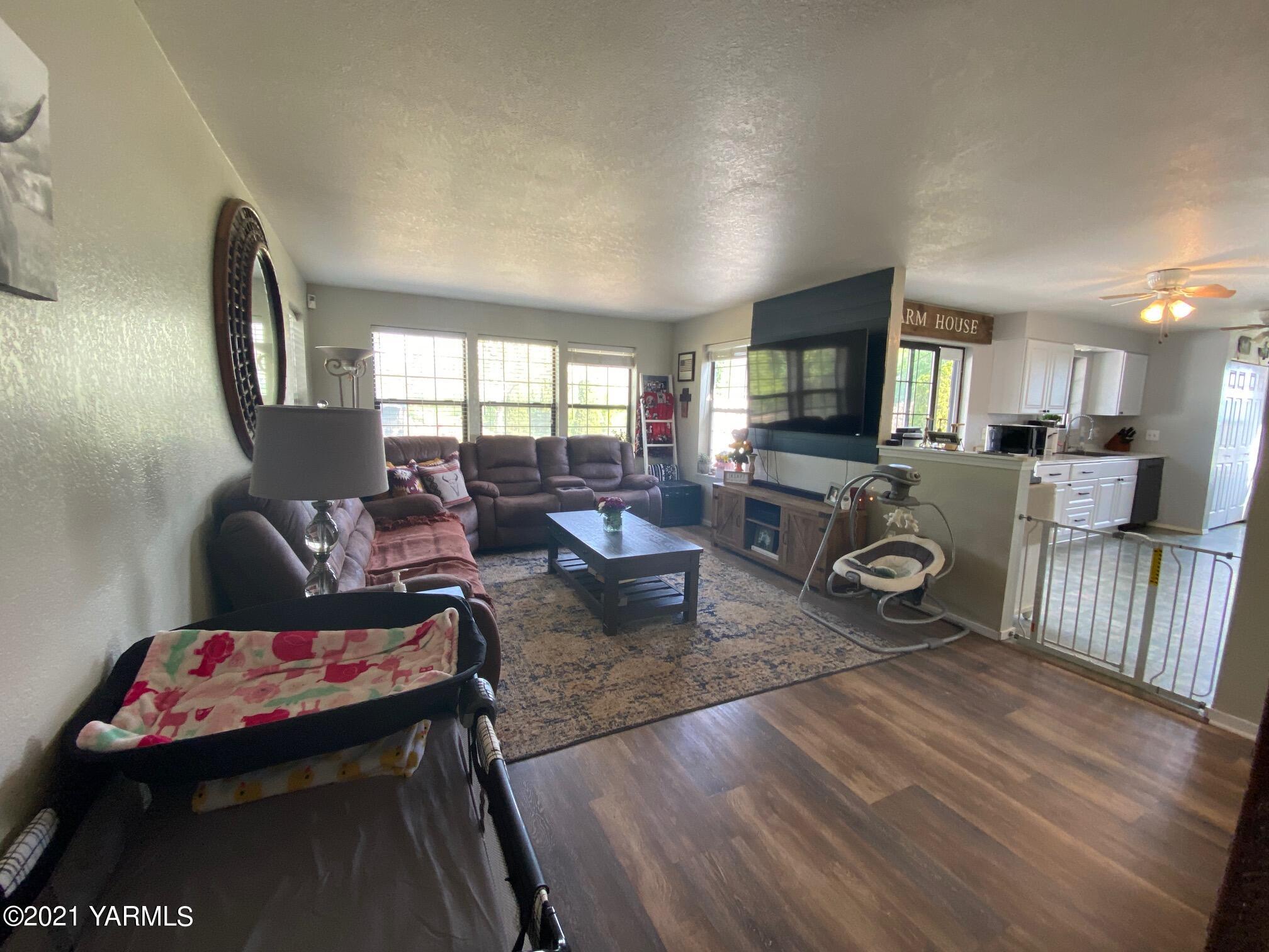 1260 Beffa Road Tieton, WA 98947 - Photo 6 of 38 a living room with furniture a flat screen tv and a fireplace