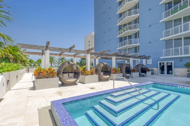 a view of a patio with plants and chairs