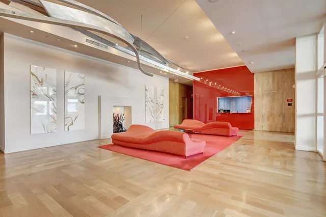 a living room with furniture fireplace and a large window