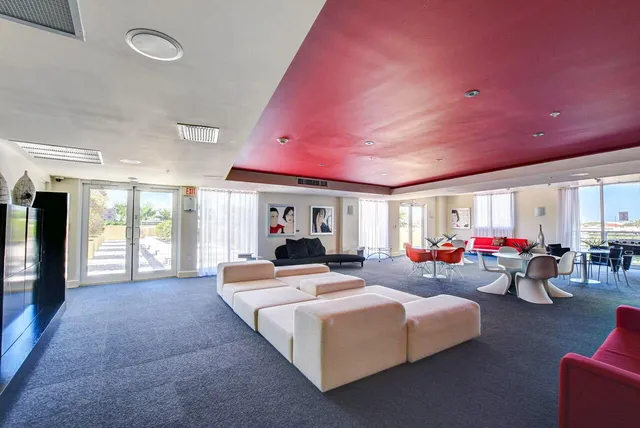 a living room with furniture a table and chairs
