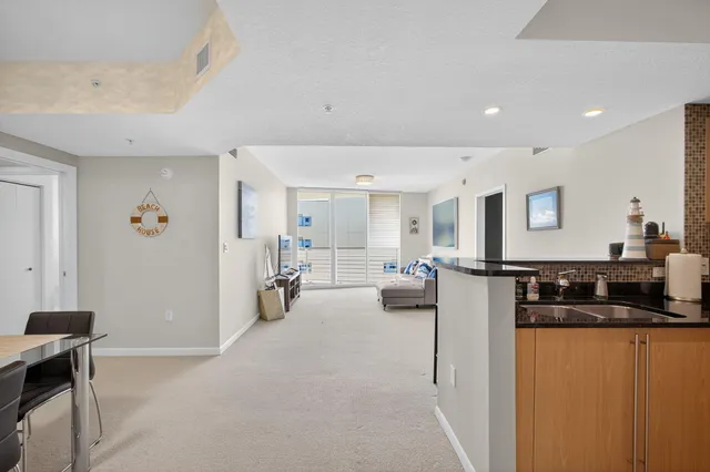 a view of a living room and kitchen