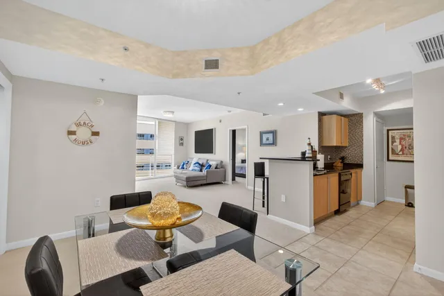 a living room with furniture and kitchen view