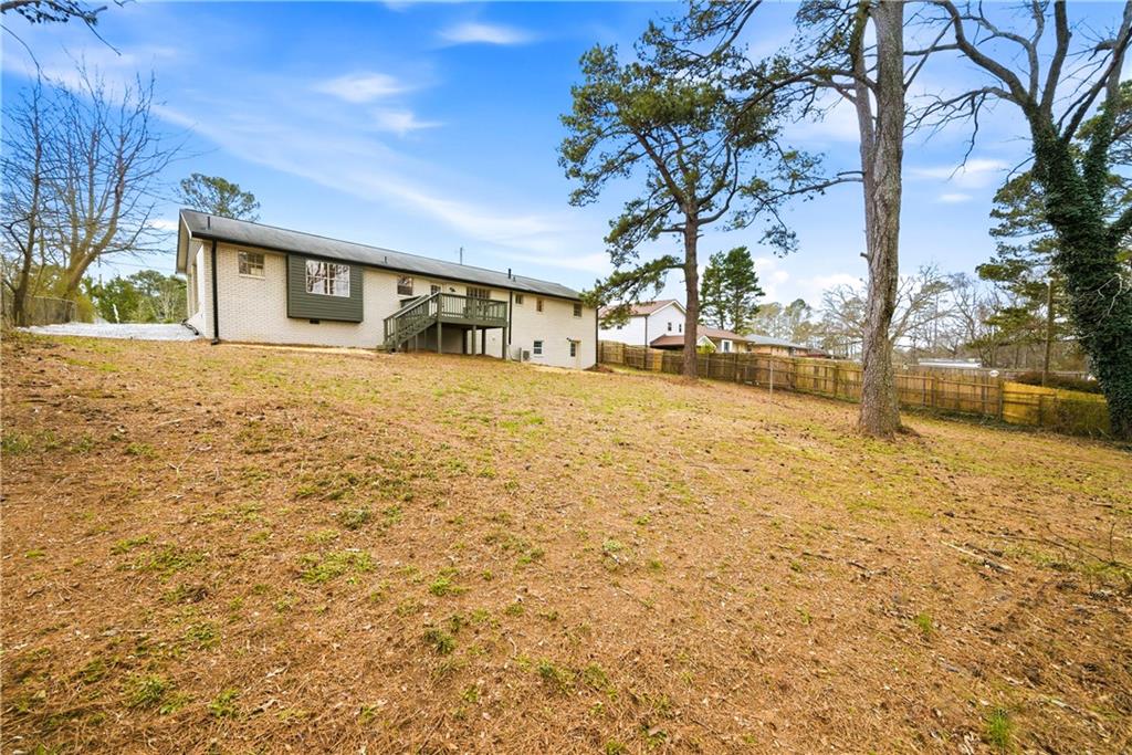 7258 Banks Mill Road Douglasville, GA 30135 - Photo 22 of 23 a view of a house with a yard and garage