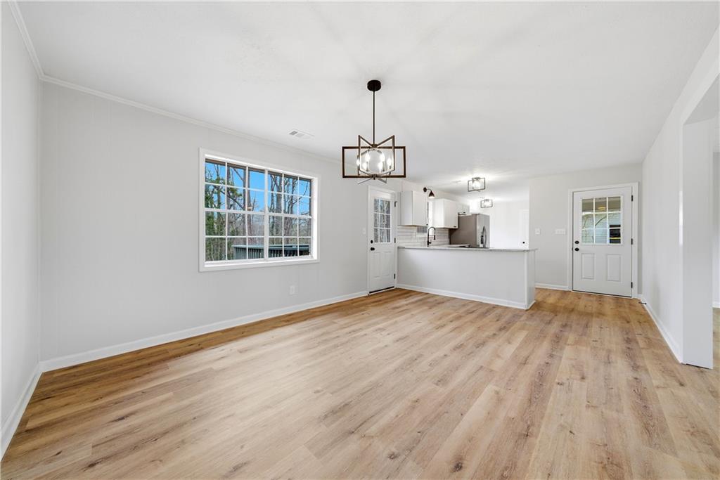 7258 Banks Mill Road Douglasville, GA 30135 - Photo 4 of 23 a view of empty room with wooden floor and windows