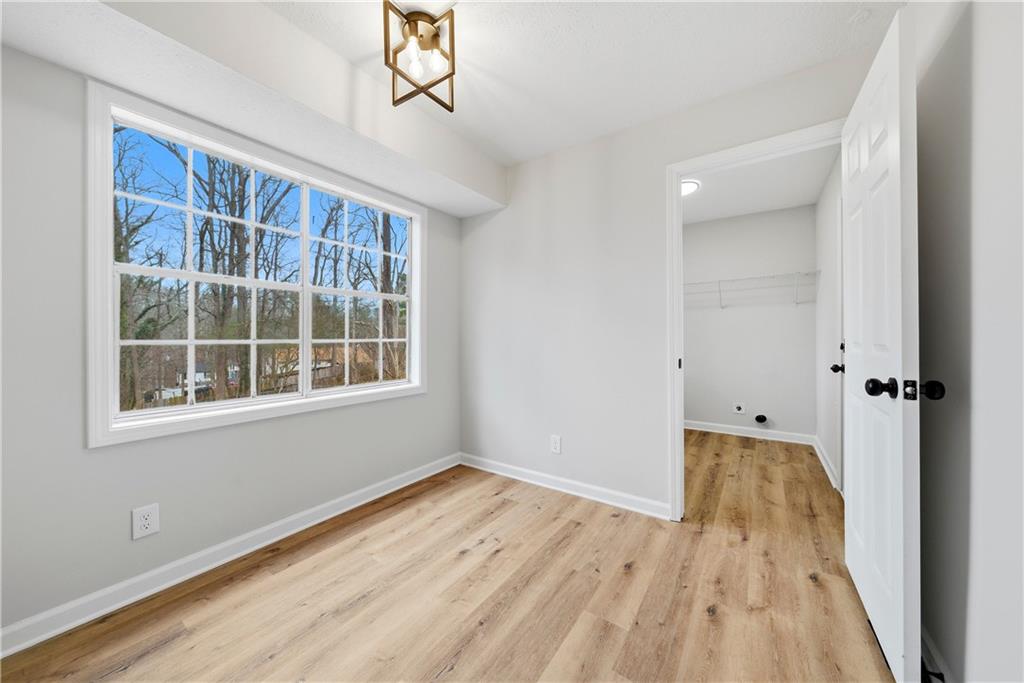 7258 Banks Mill Road Douglasville, GA 30135 - Photo 7 of 23 wooden floor in an empty room with a window